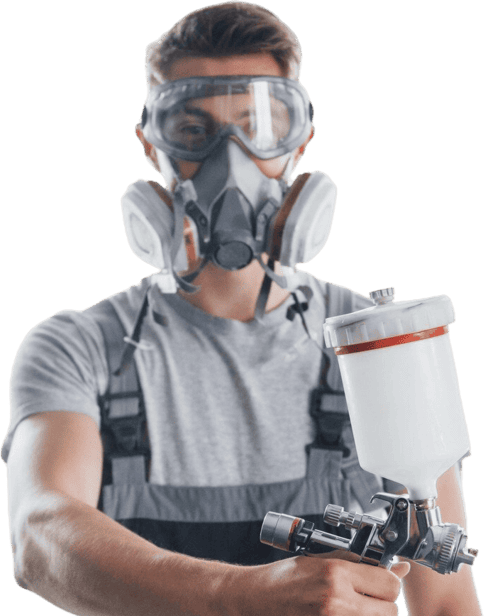 Hombre con pistola y mascarilla de pintura